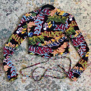 Multi-coloured graffiti print long sleeve mock neck crop top